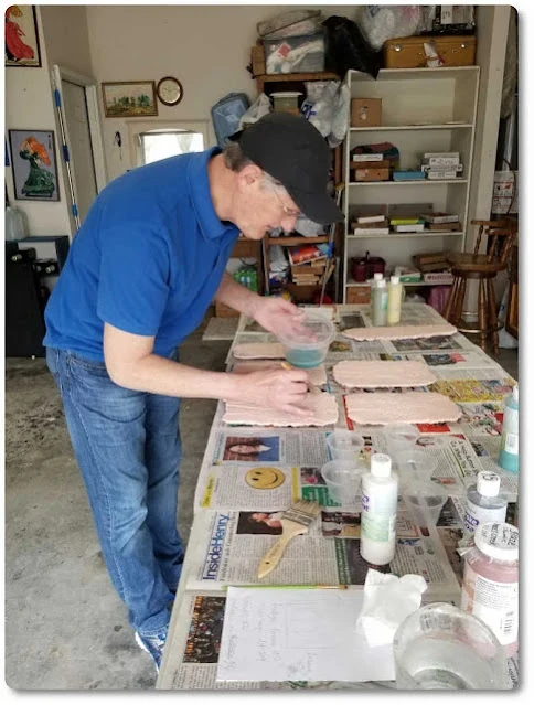 Ed at work creating ceramic wall decor artwork