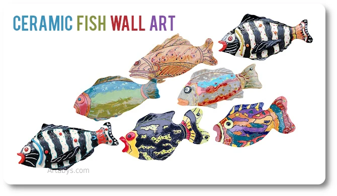 Similar ceramic fish designs grouped together on the wall