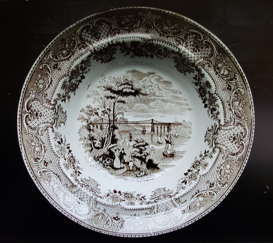 A Staffordshire porcelain stoneware plate from the 1850s, with a white glaze and a transfer printed design. Visually, these is very similar to earthenware or porcelain counterparts