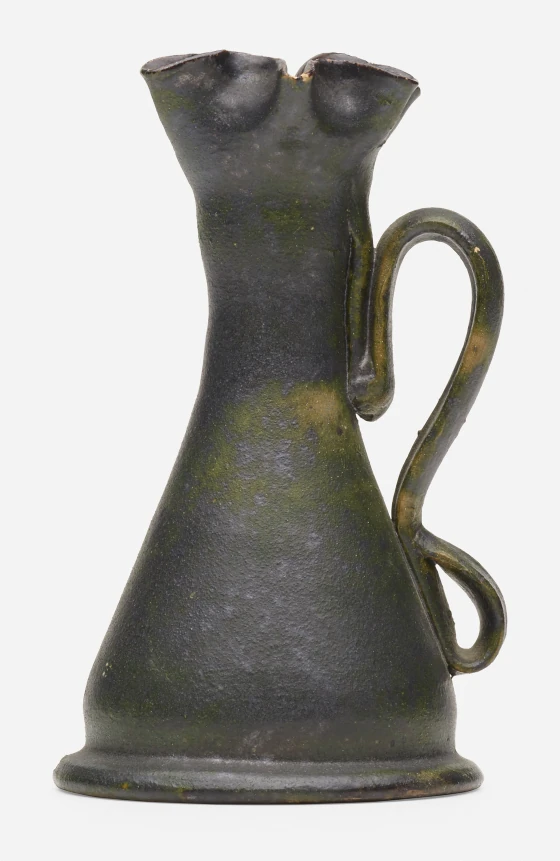 George E Ohr Chamberstick 1898-1910, glazed earthenware features a ruffled rim and green and gunmetal glaze